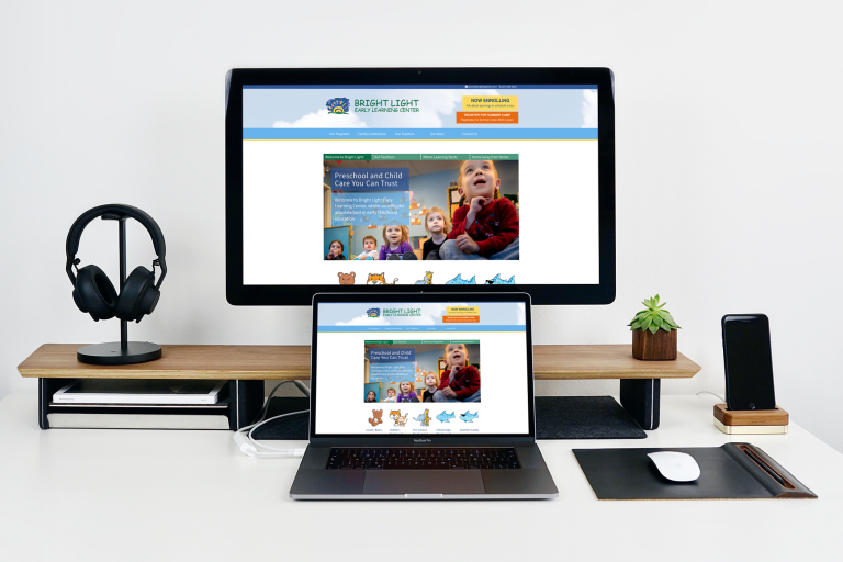The Bright Light ELC website loading on a desktop monitor and a laptop screen